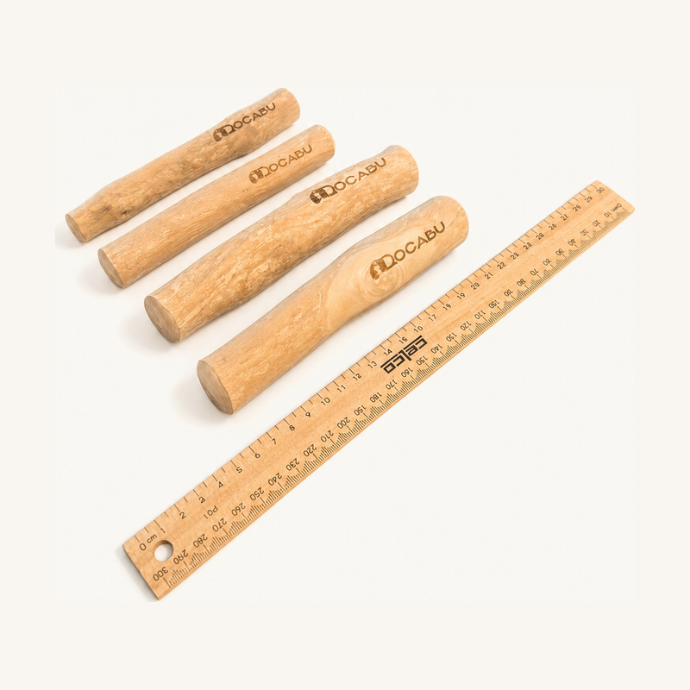 Four Docabu coffee wood chews beside a 30cm ruler — the two at the back are Small, the two at the front are Medium and noticeably thicker